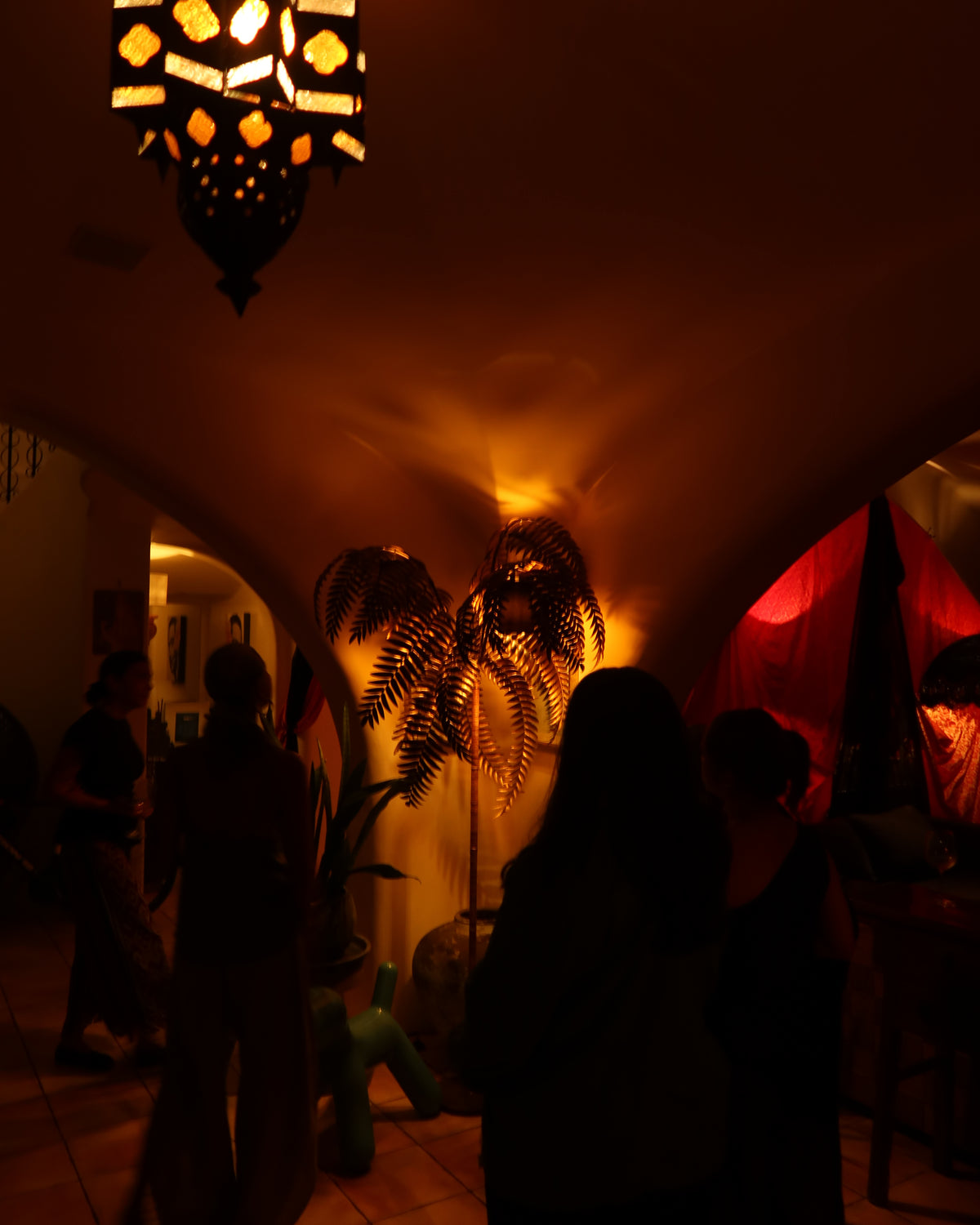 Guests moving through a warmly lit creative home during Creativity, Lived. Photo courtesy of With Meraki Travel Collection.