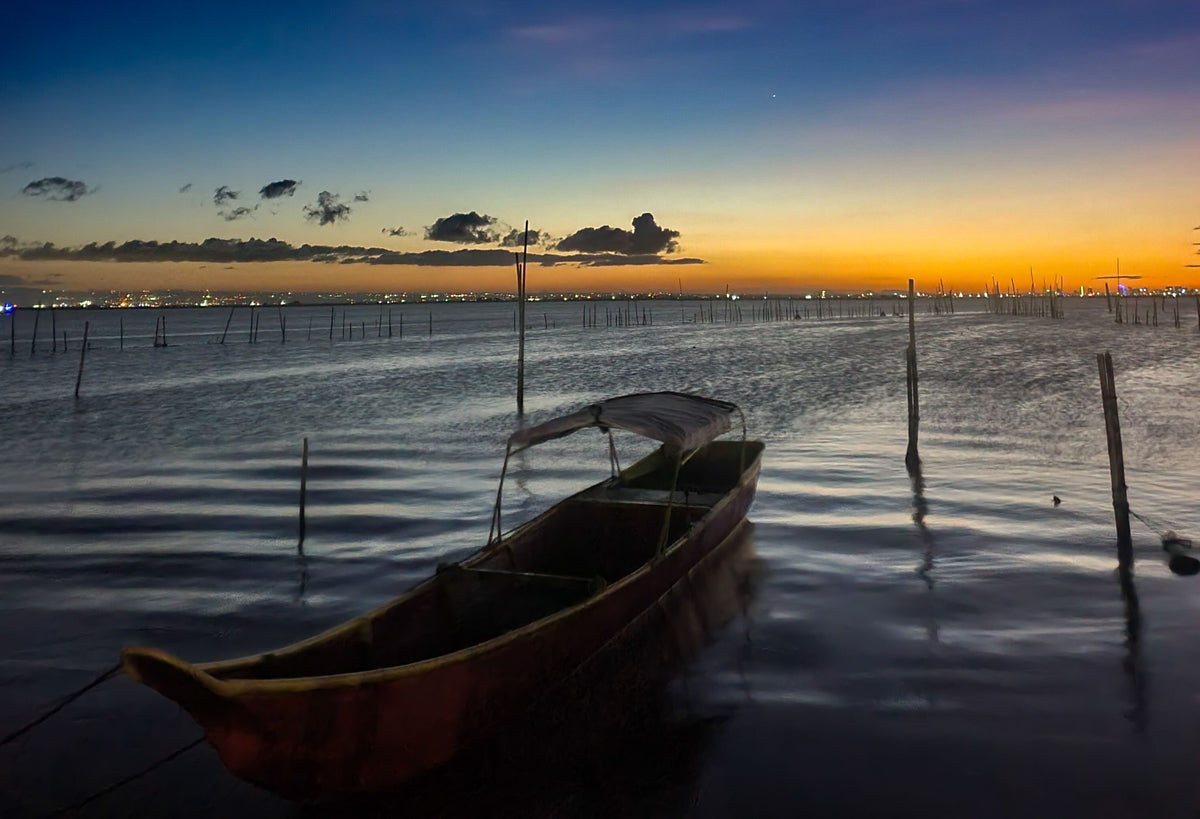 Traditional wooden boat on Laguna de Bay at dusk