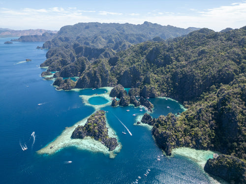 Sunlit island channels and cobalt-blue water in Coron, Palawan; aerial photograph by Florian Delée on Unsplash, https://unsplash.com/photos/N7DQsSuByOY